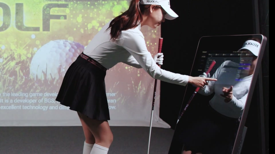 Golfer using the KStadium touchscreen kiosk