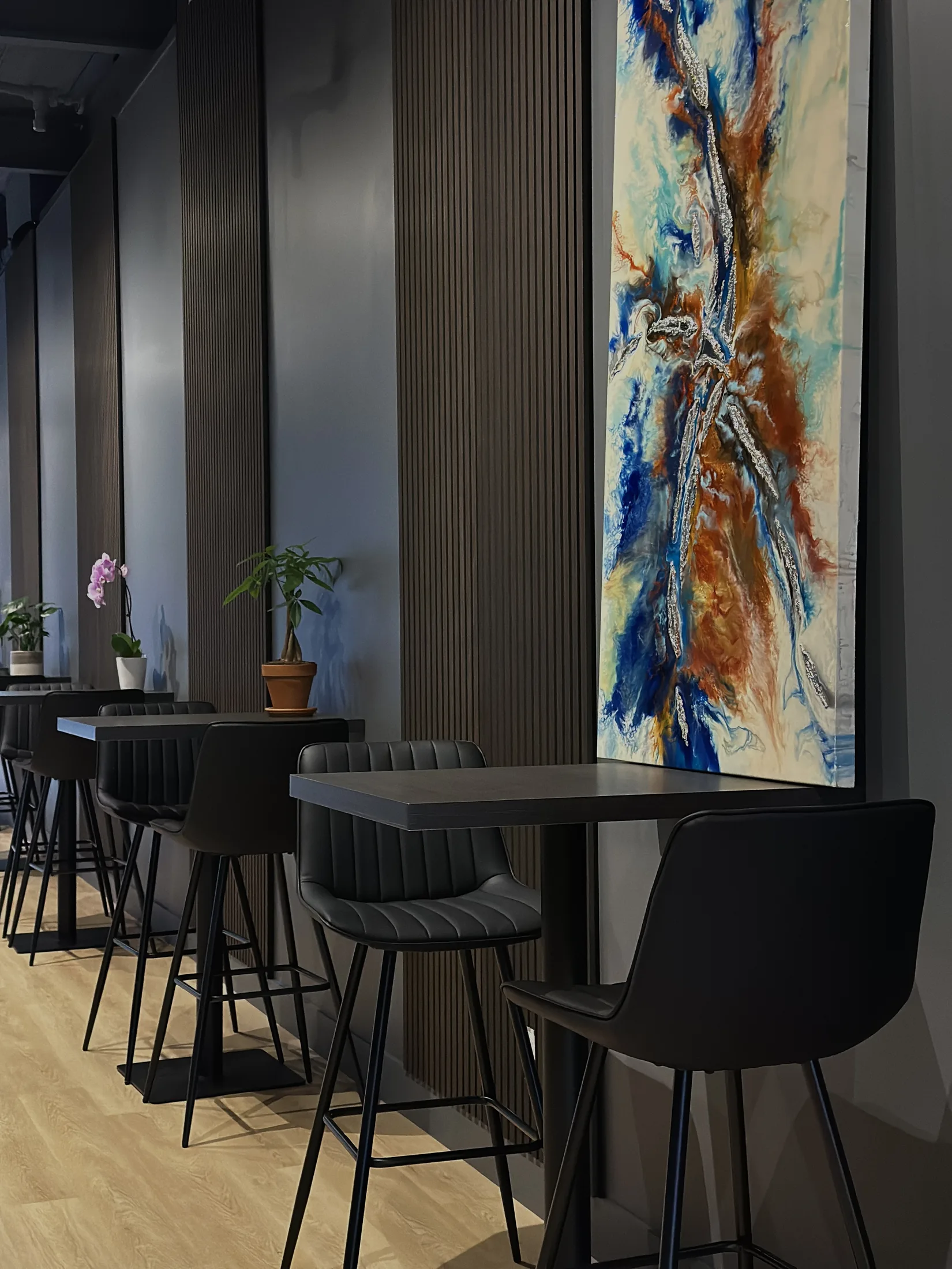 Waiting area with tables, seating, and wall art